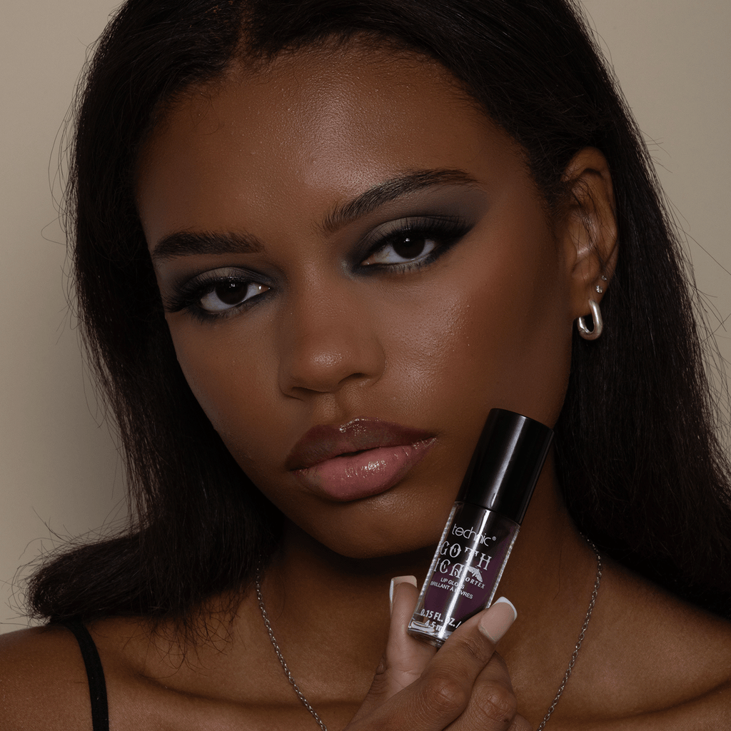 Model holding the black and purple swirl lip gloss.