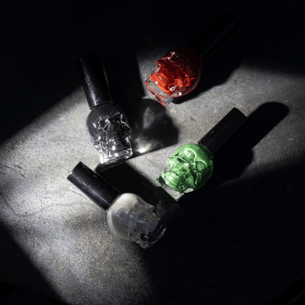 All 4 nail varnish colours laying down with a shadow effect.