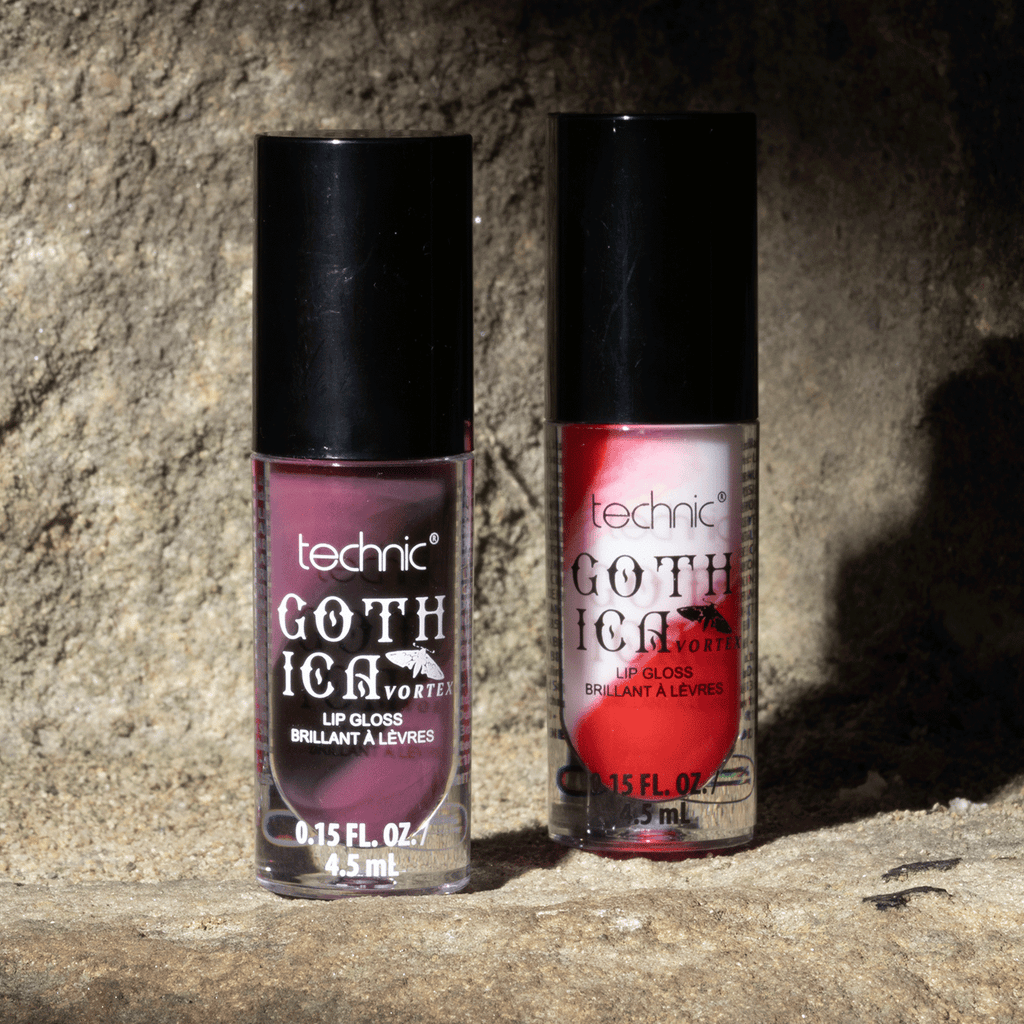Both swirl lip glosses next to each other on a stone wall.