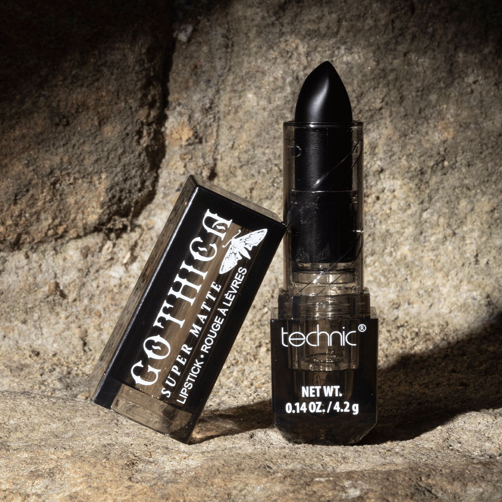 Opened black lipstick on a stone wall with a shadow effect.
