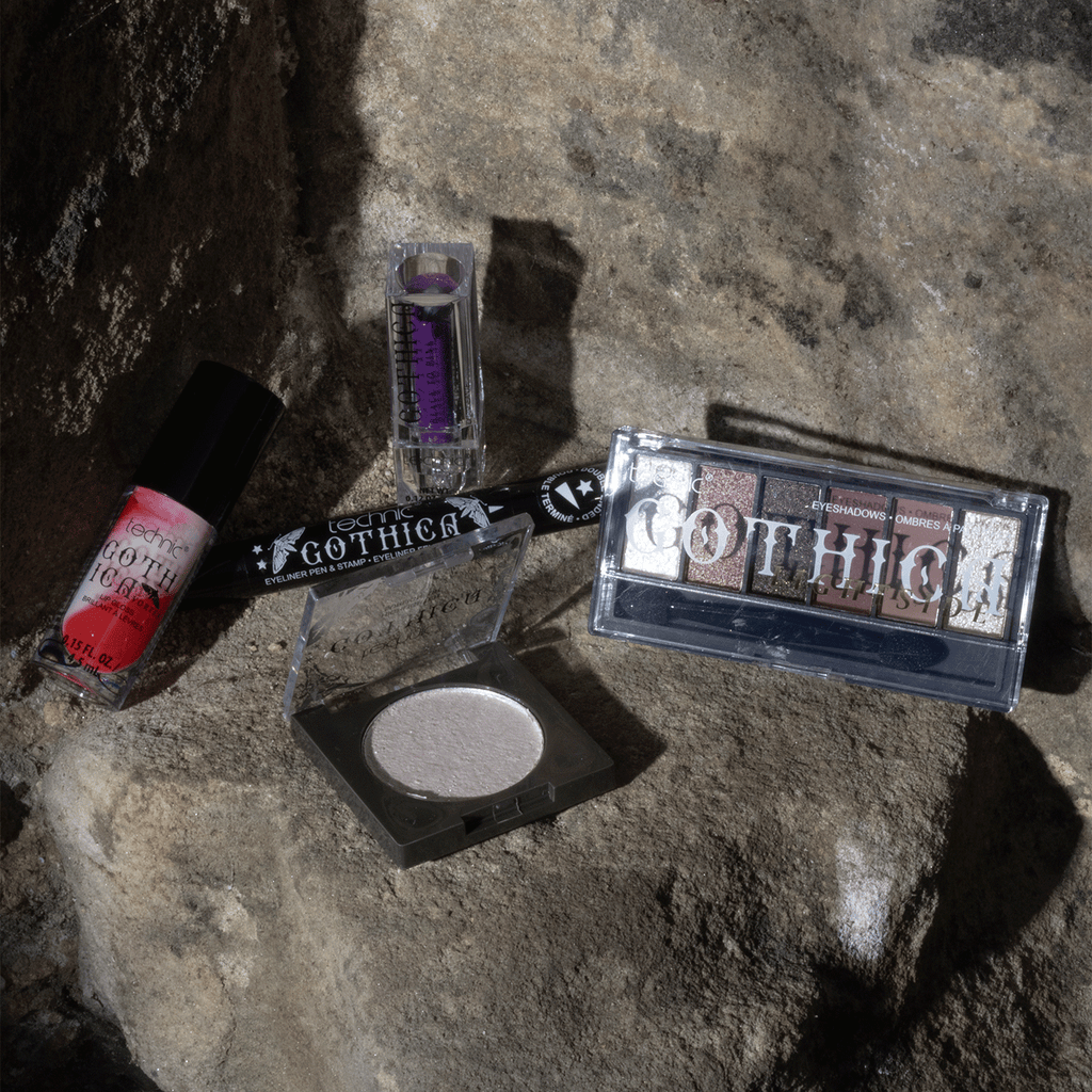 Some other gothica products including lip gloss, eye liner, an opened highlighter, an eyeshadow palette and a colour changing lip balm.