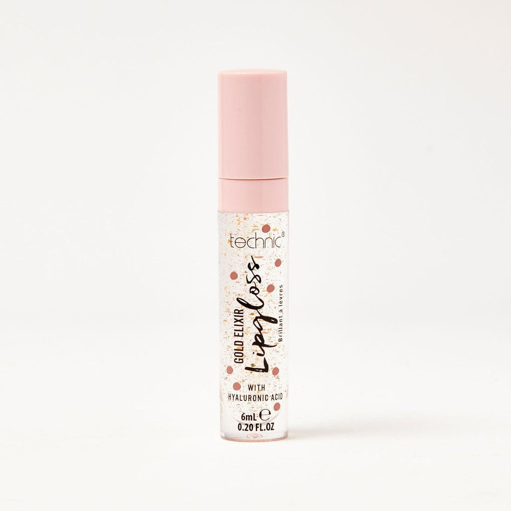 A gold elixir lip gloss in front of a white background.