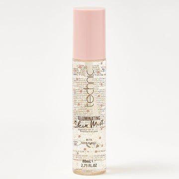 An illuminating skin mist in front of a white background.
