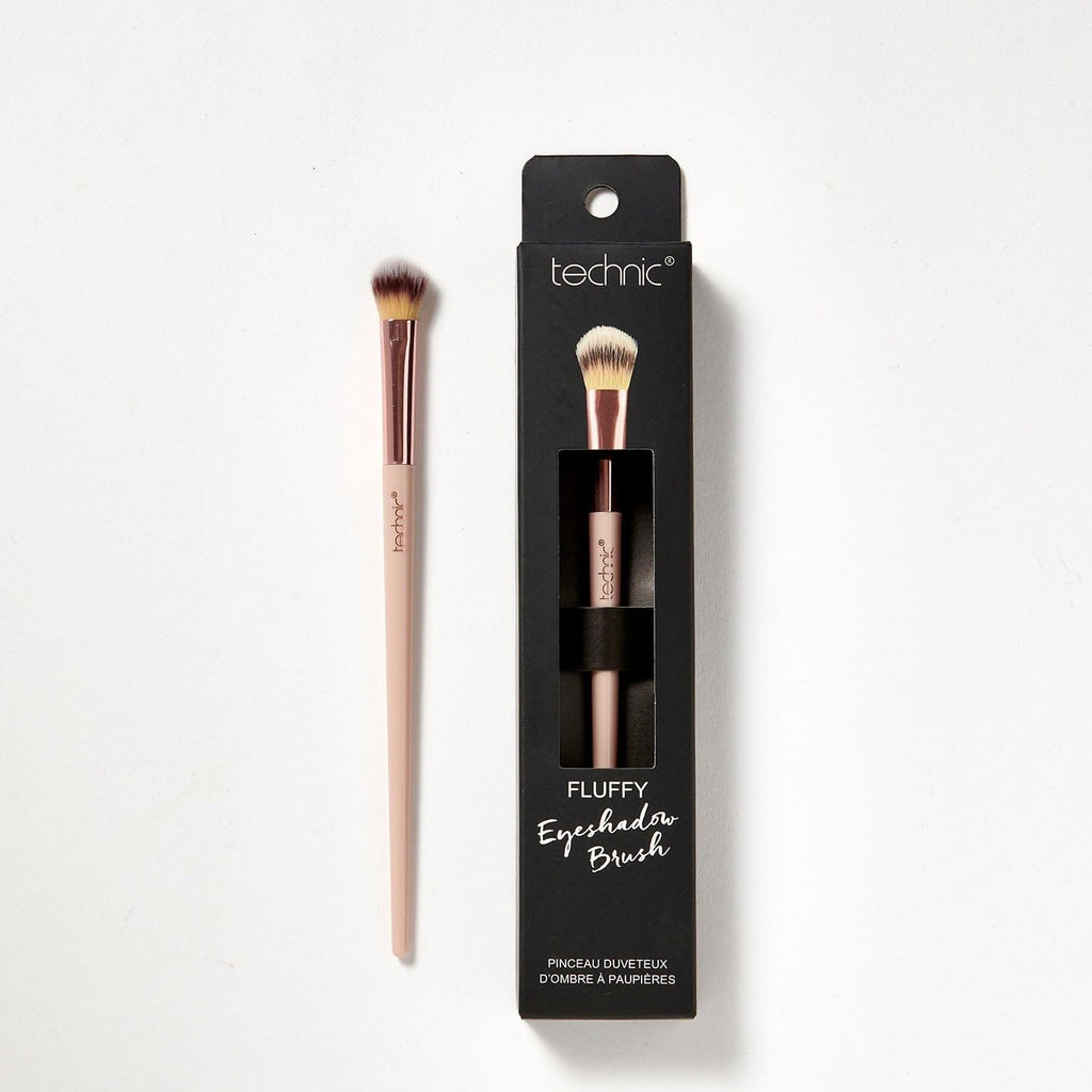 2 fluffy eyeshadow brushes on a white background. 1 is in its original packaging which is black and has an image of he brush on the front, and the other is out of the packaging.