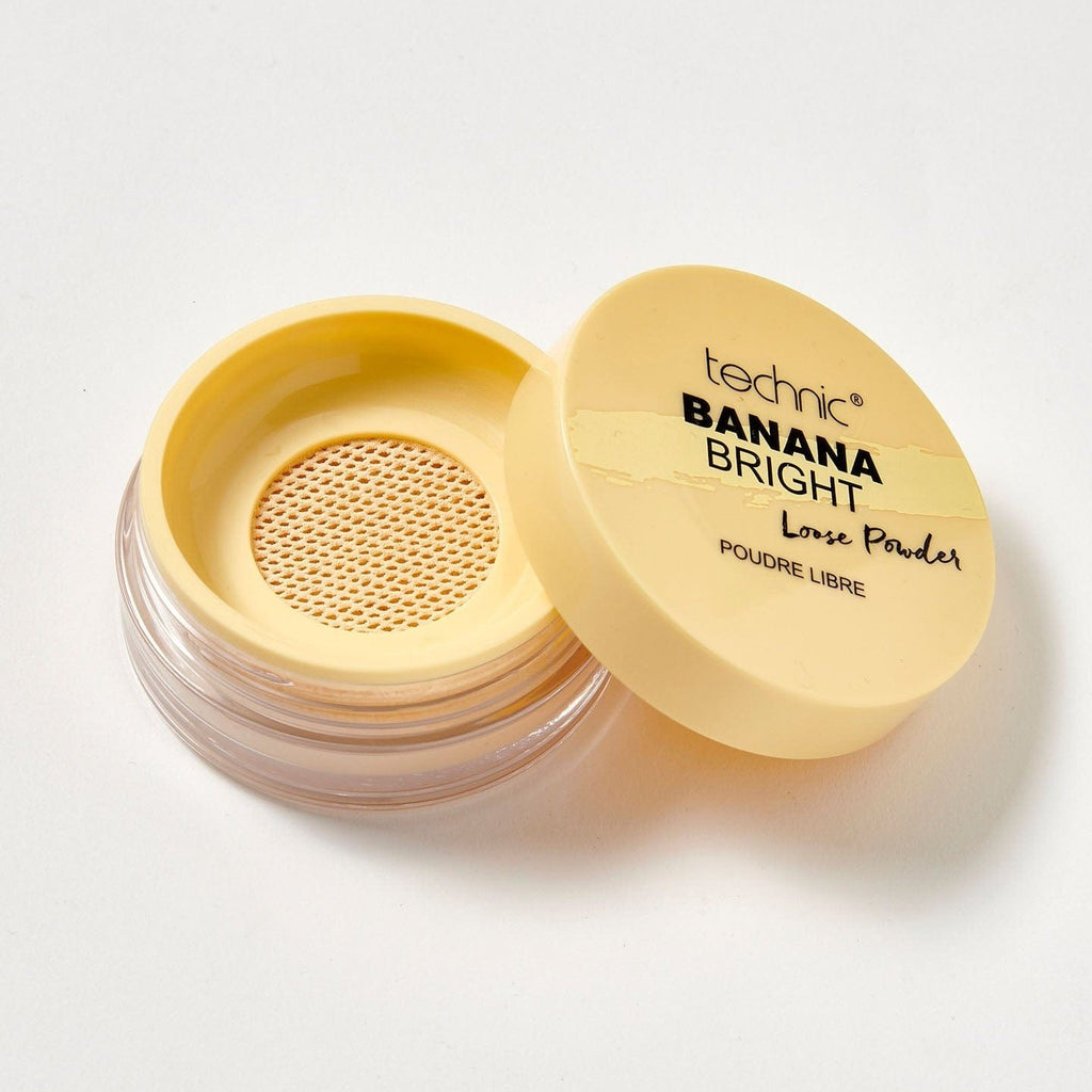 An opened banana bright loose powder on a white background.
