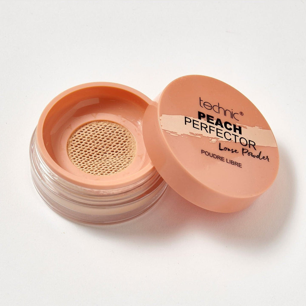 An opened peach perfector loose powder on a white background.