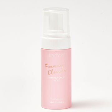 A foaming cleanser bottle in front of a white background.