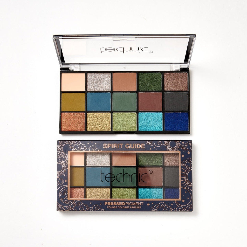 2 spirit guide eyeshadow palettes on a white background. 1 is in its navy blue box with gold patterns on it and the other is opened and out of the packaging.