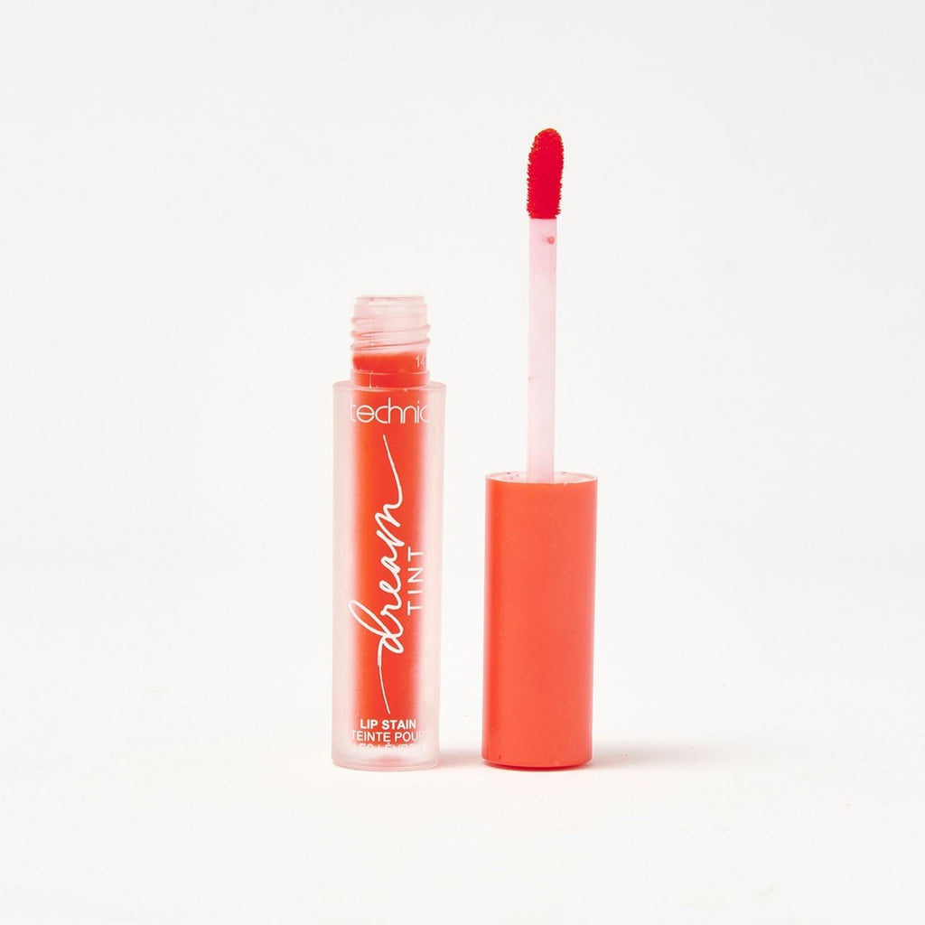 An opened dream lip tint in the shade Red Coral on a white background.