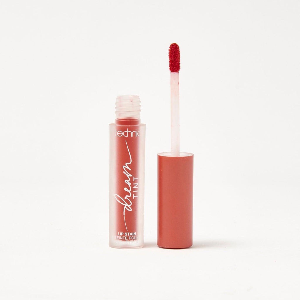 An opened dream lip tint in the shade Red Veil on a white background.