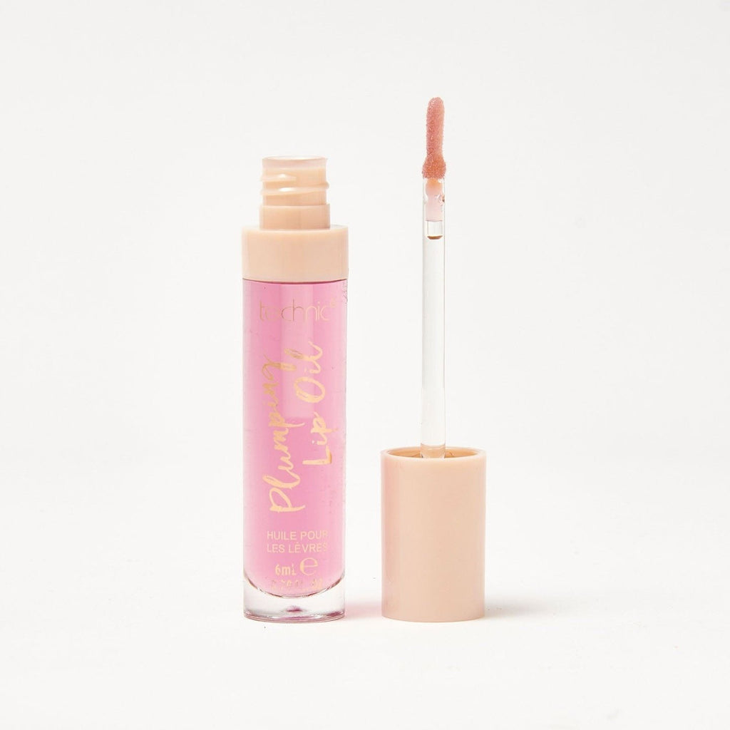 An opened plumping lip oil in the shade Berry Wow on a white background.