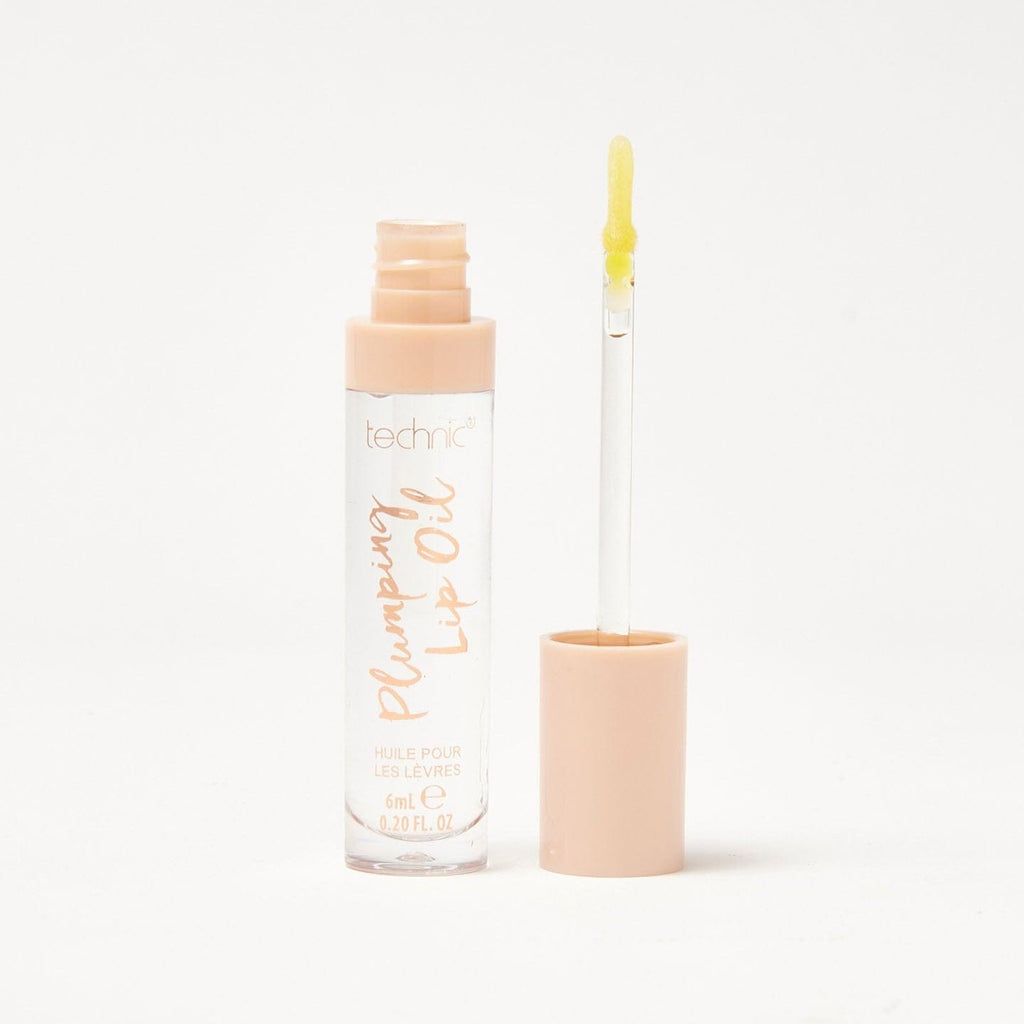 An open plumping lip oil in the shade Sweet Thing on a white background.