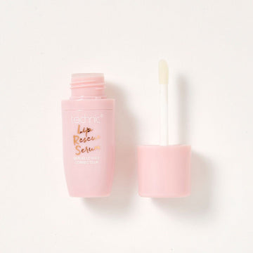 An opened lip rescue serum in a pink tube on a white background.
