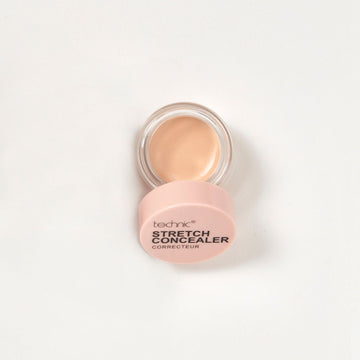 An opened stretch concealer in the shade Beige on a white background.