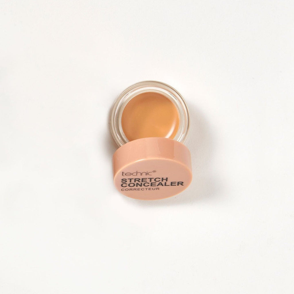An opened stretch concealer in the shade Warm Tan on a white background.