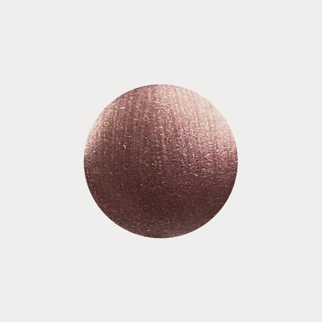 A swatch of the shade Seashell. It is a shimmery bronze colour.