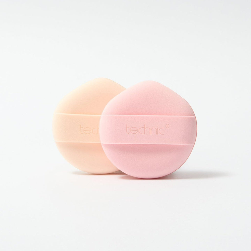 Both sponge puffs out of packaging in front of a white background.