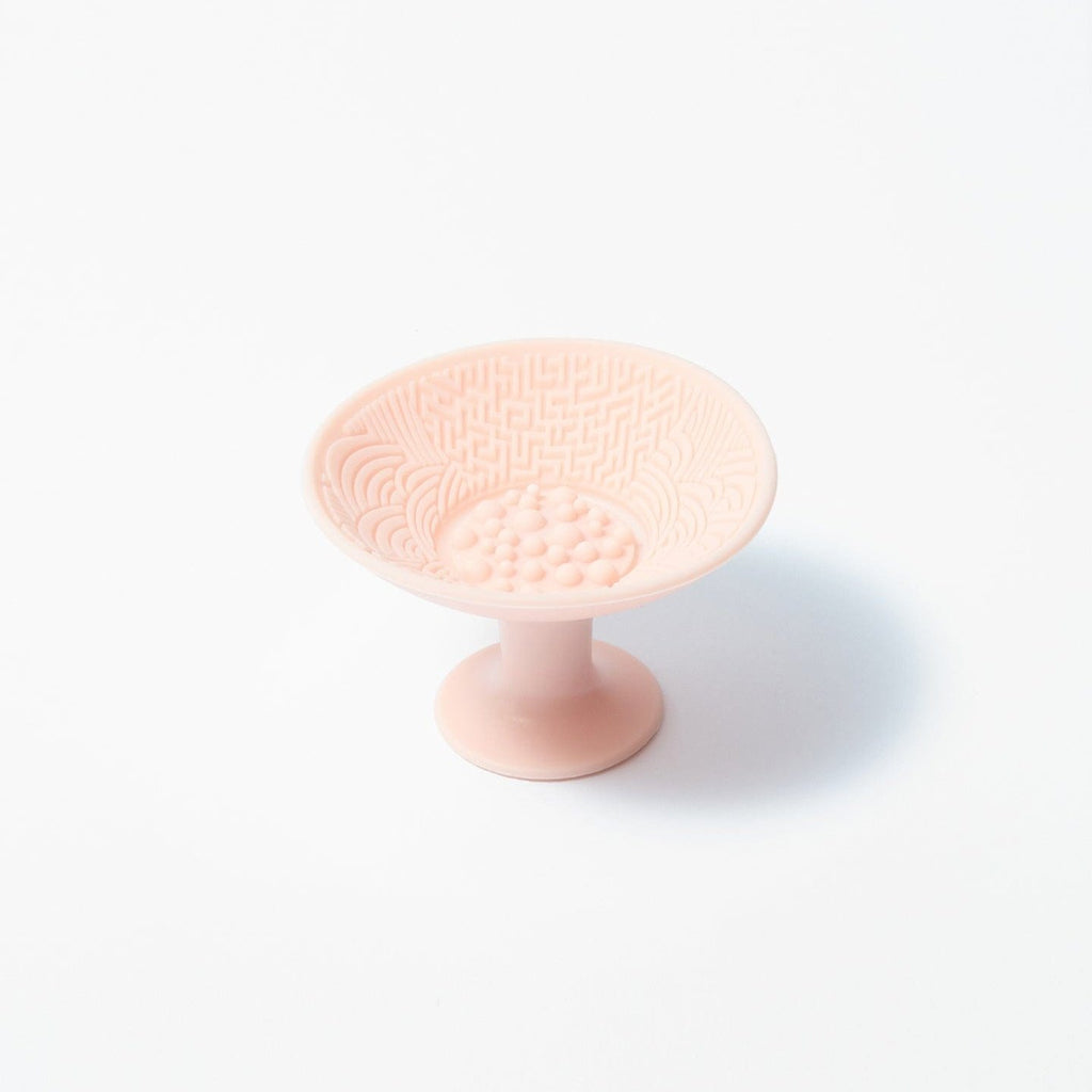 A swirl and clean brush cleaner out of packaging in front of a white background.