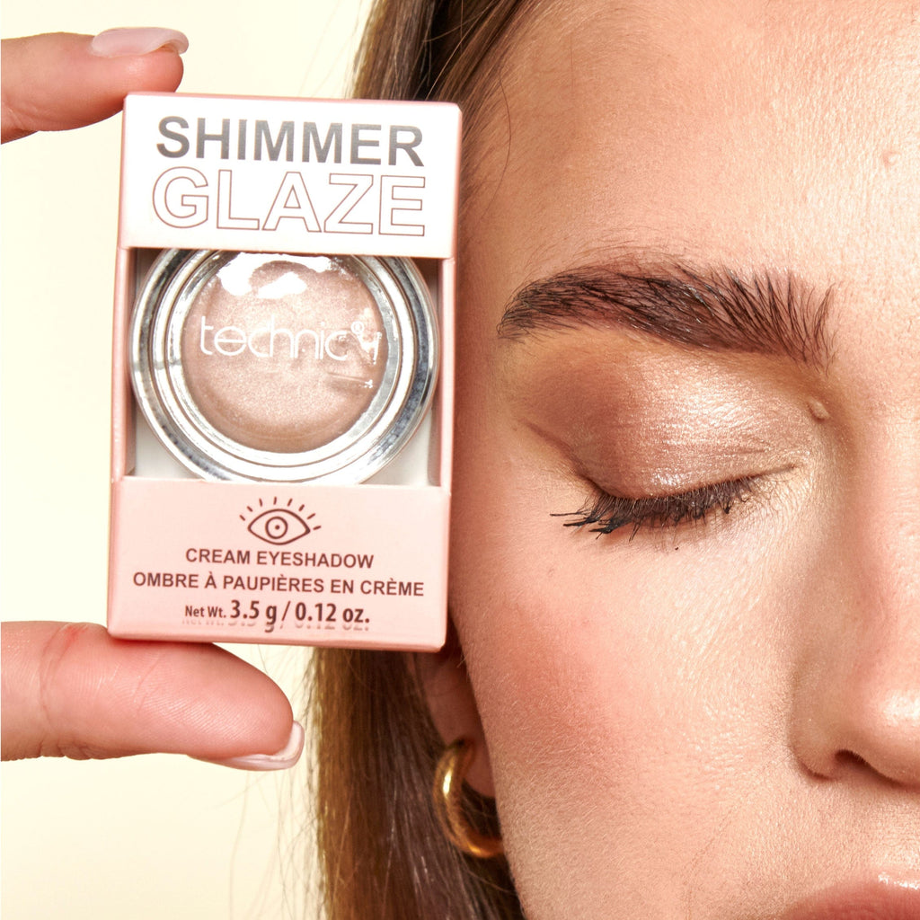 Close up of a model holding the cream eyeshadow next to her eye with the product applied to her eyelid.