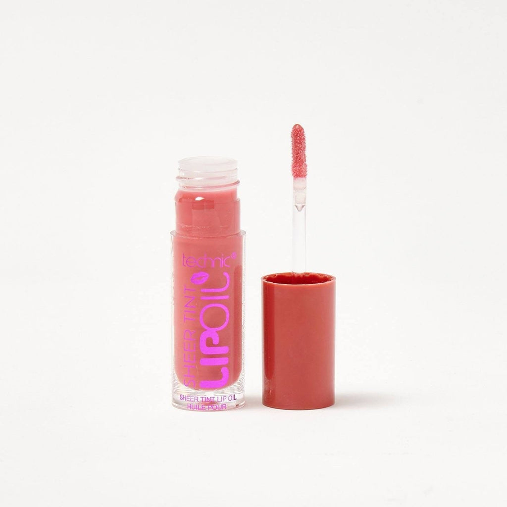 An opened sheer lip oil in the shade Punch Bowl on a white background.