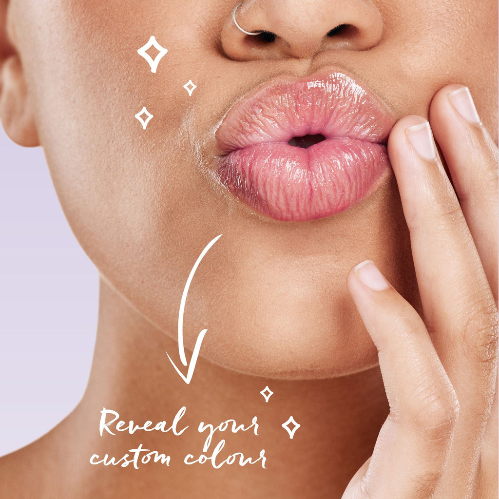 Close up of models lips with product applied. Arrow with text saying "Reveal your custom colour"