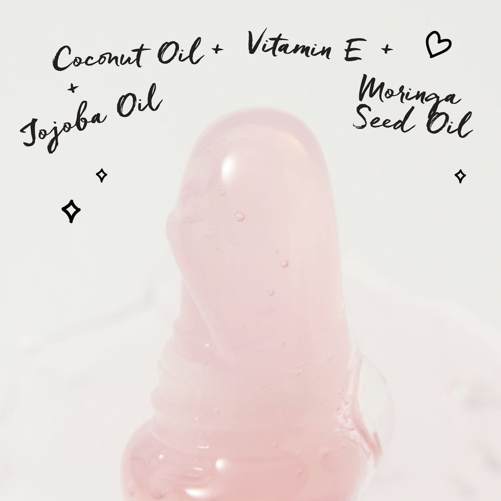 A close up of the water gloss with the key ingredients written around it. They are Jojoba Oil, Coconut Oil, Vitamin E, Moringa Seed Oil.