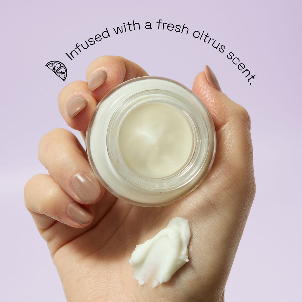 Models hand holding the product with text saying it is infused with a fresh citrus scent.