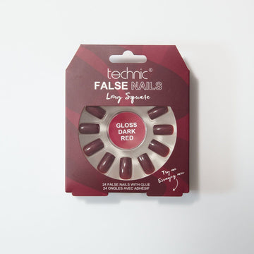 Gloss dark red long square nails in a red patterned box on a white background.