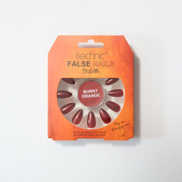 Burnt orange stiletto nails in an orange box on a white background.