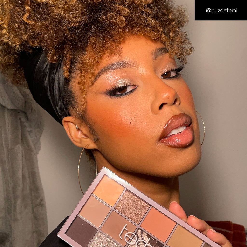 Model holding the Smokey quartz palette with a subtle shimmery eye look.
