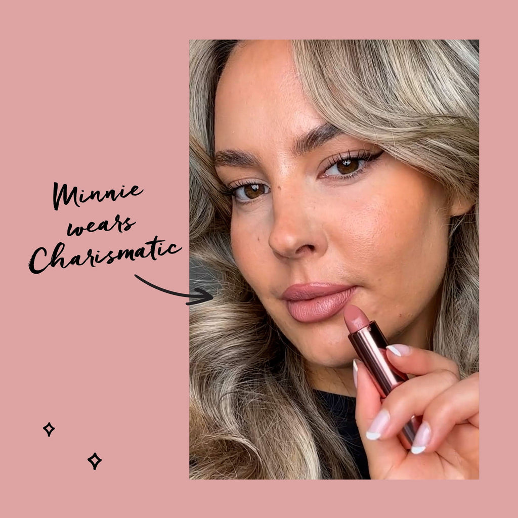 Model holding lipstick shade and text saying she used the shade Charismatic 