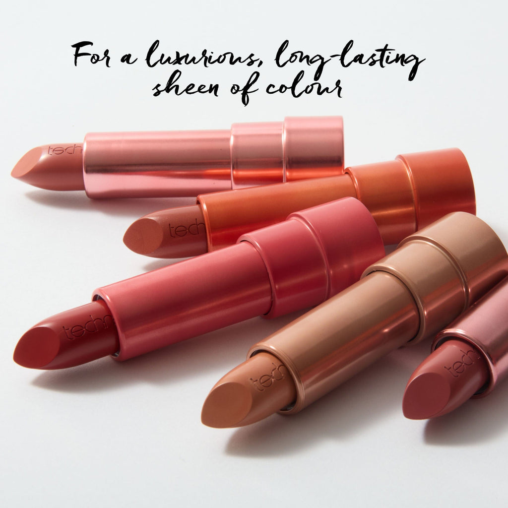 The 5 lipsticks opened and laying on a white background. 