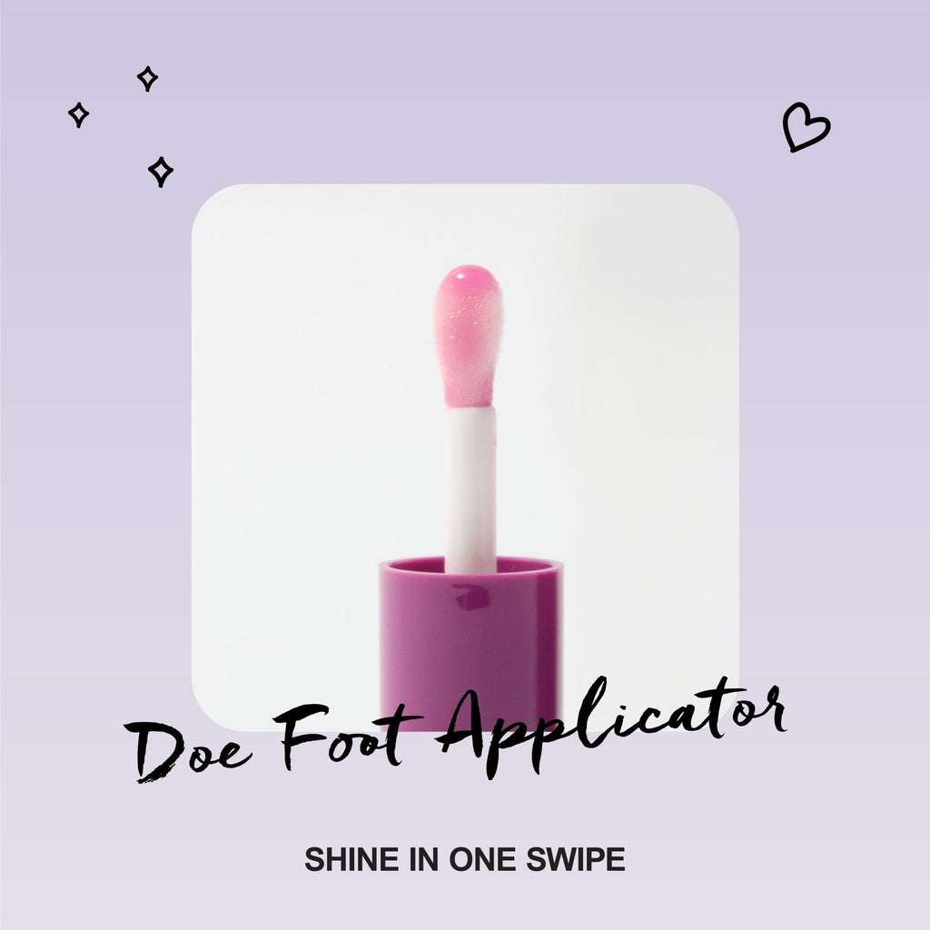 A close up of an opened lip oil to show the doe foot applicator.