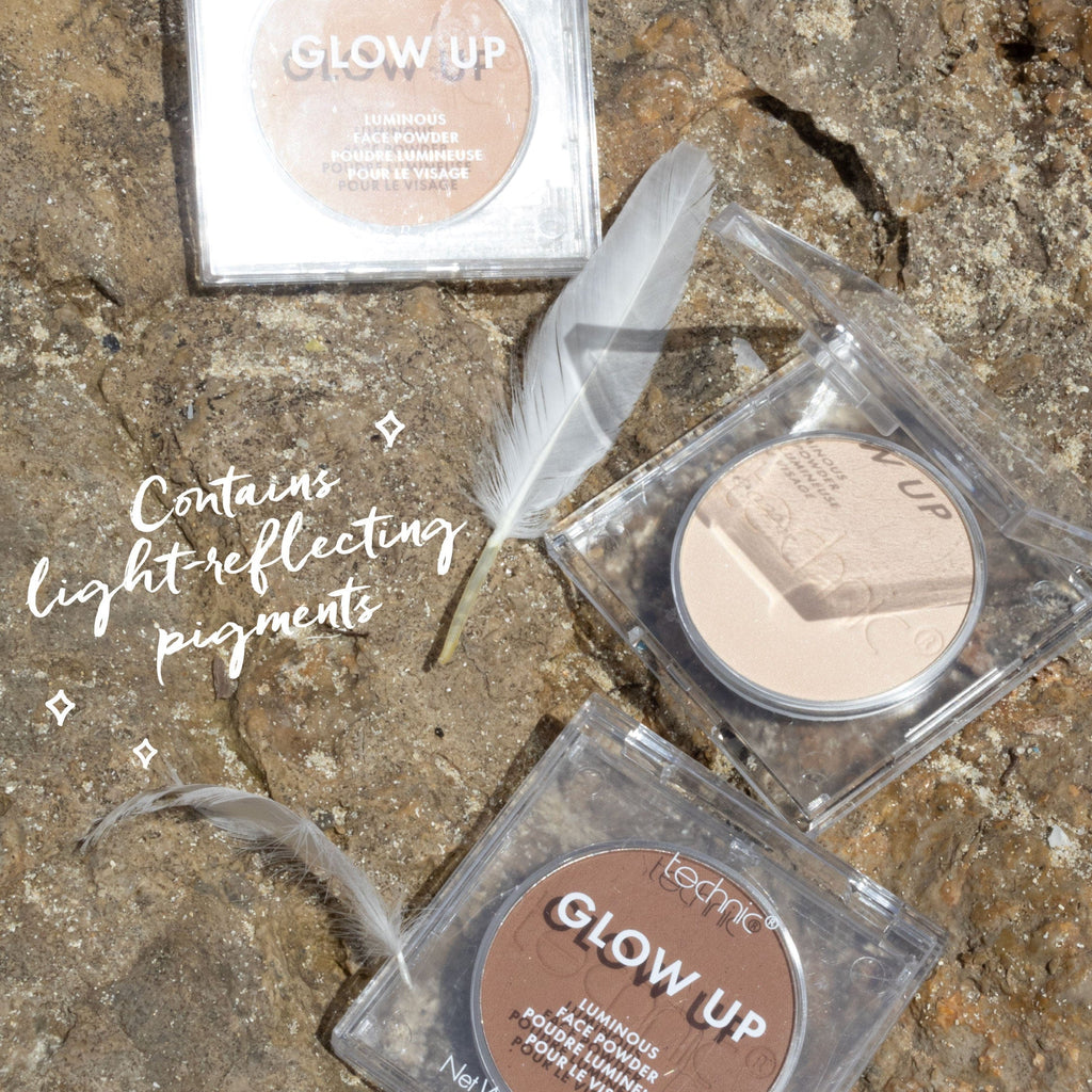 3 of the powders on a rock with 2 white feathers around them. Text saying "Contains Light-Reflecting Pigments"