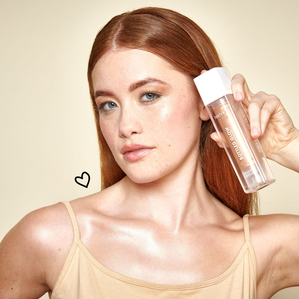 Model holding bottled glow next to her face.