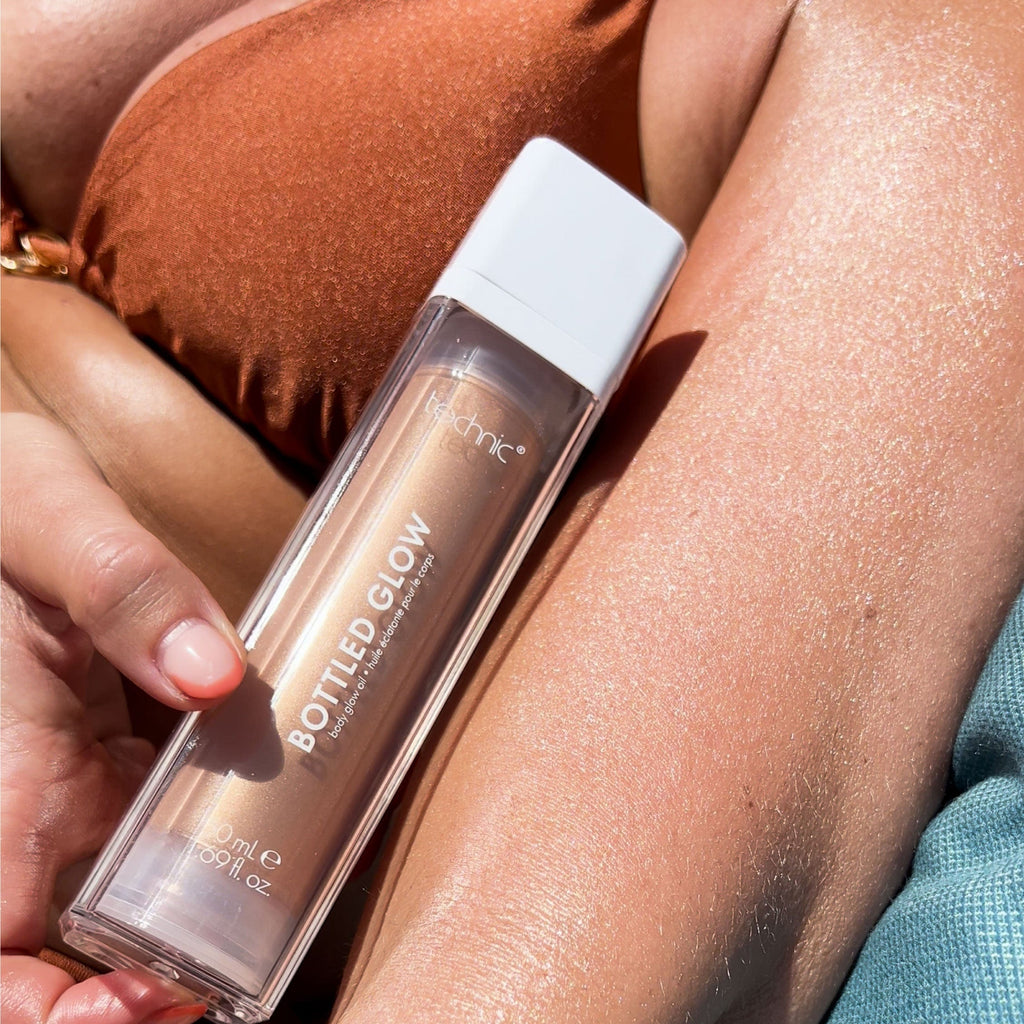 A close up of a models arm with the bottled glow applied to her arm in the sunlight.