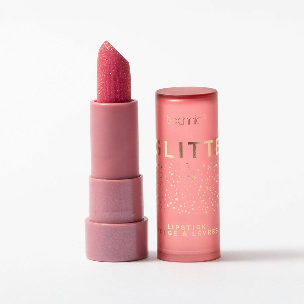 Pink glittery lipstick with packaging on a white background