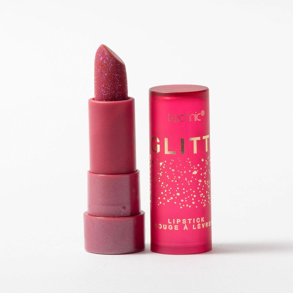 Pink glittery lipstick with packaging on a white background