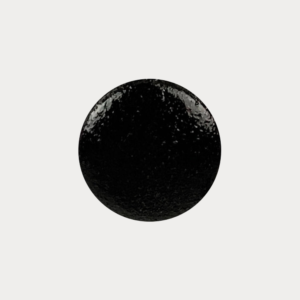 A swatch of the shade Black Velvet. It is a black colour with small silver glitters in it.
