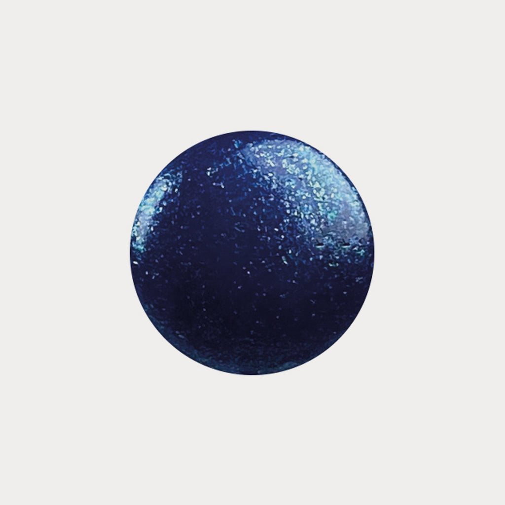 A swatch of the shade Mermazing. It is a sparkly navy blue.