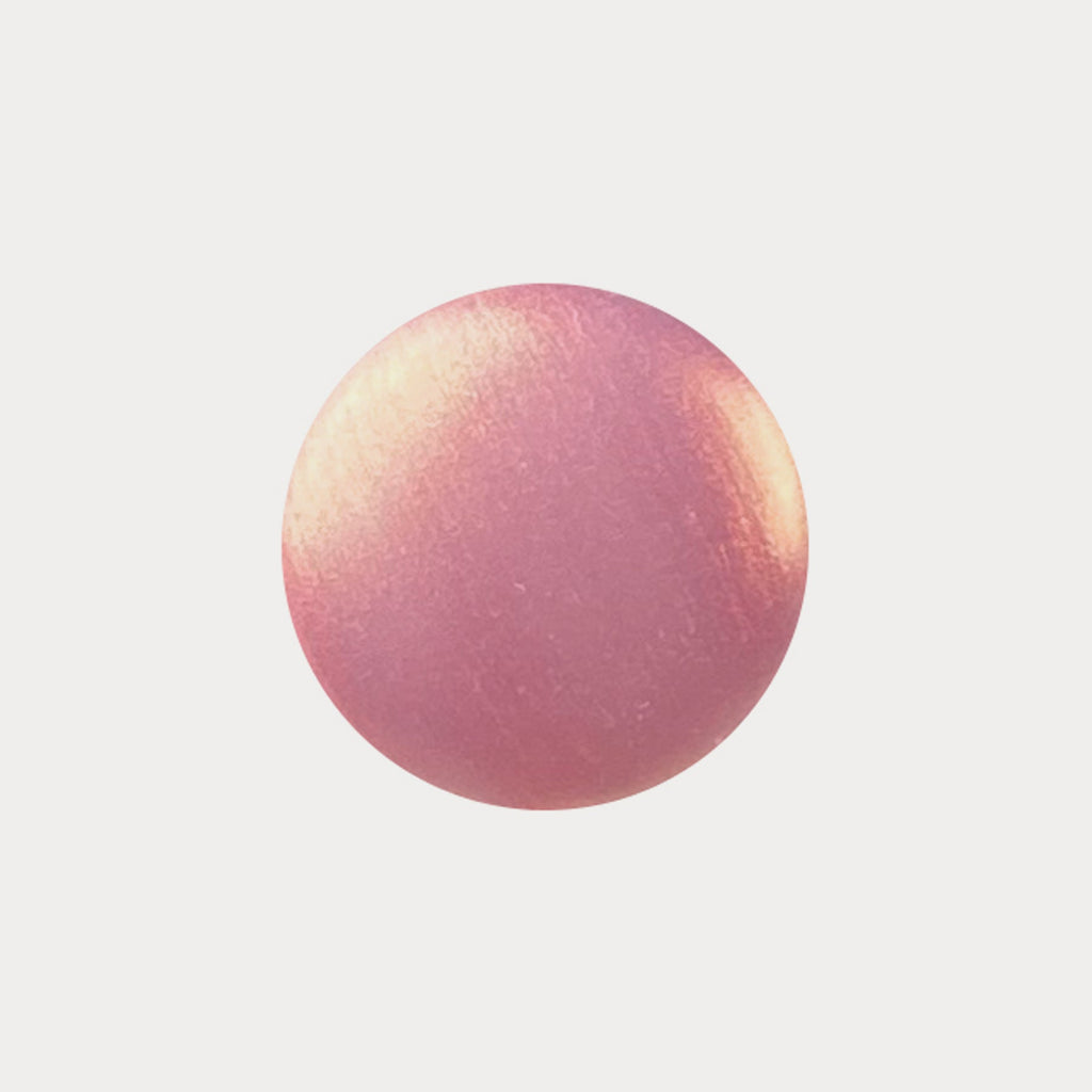 A swatch of the shade New York, New York. It is a coral pink shade with a gold shimmer.