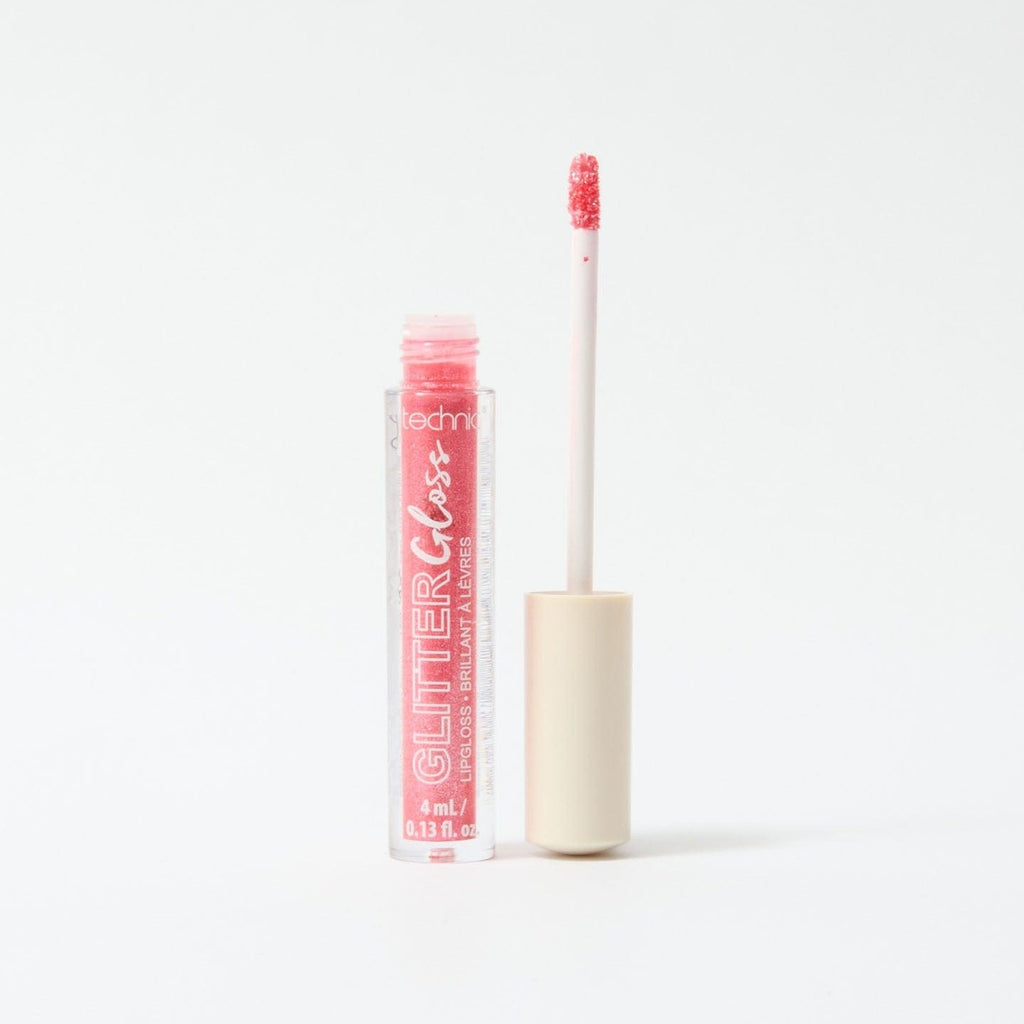 An opened glitter gloss in the shade Red on a white background.