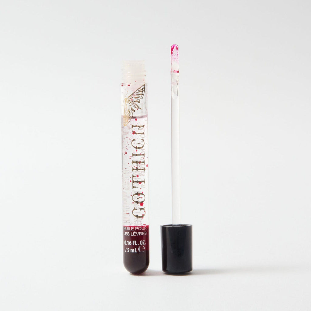 Opened gothica bloodmoon lip oil on a white background.