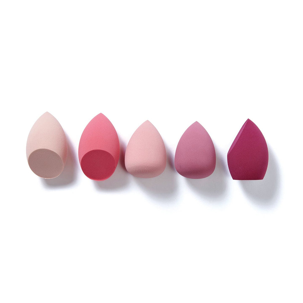 All 5 of the makeup sponges out of the giftset packaging on a white background. All 5 makeup sponges are a range of different shapes.