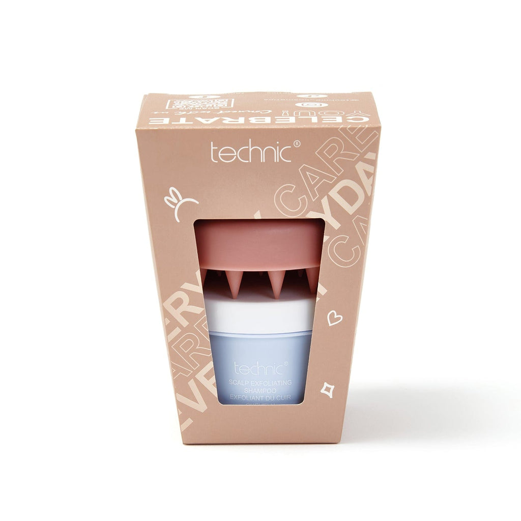 Scalp care gift set on a white background. The gift set is in a beige box with a scalp exfoliating shampoo and a scalp massager inside.