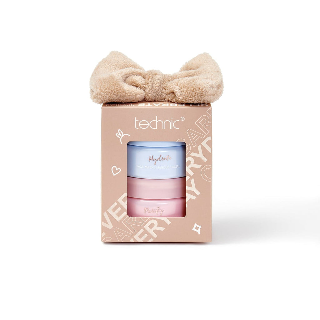 The face mask gift set on a white background. 2 face masks are in the beige coloured gift set box with a bow headband inside.