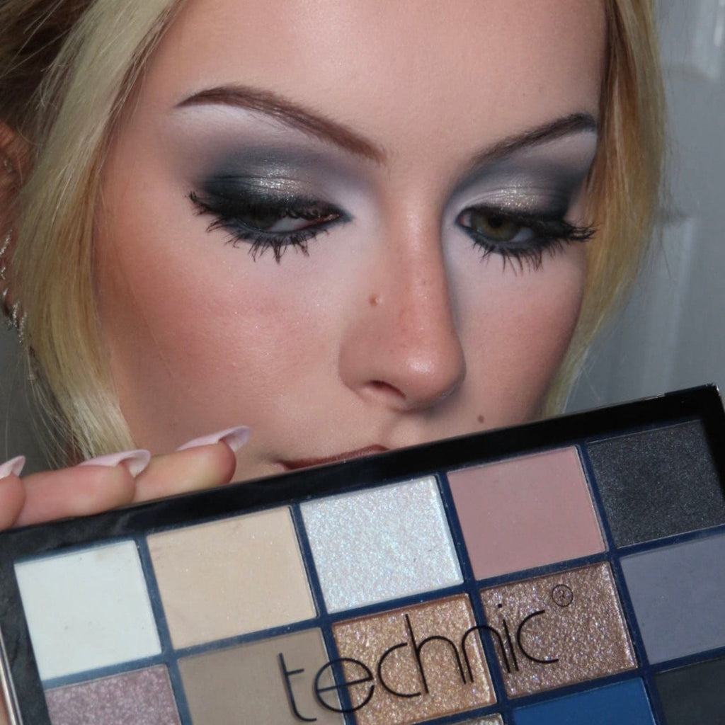 Woman holding a Technic eyeshadow palette with a neutral background
