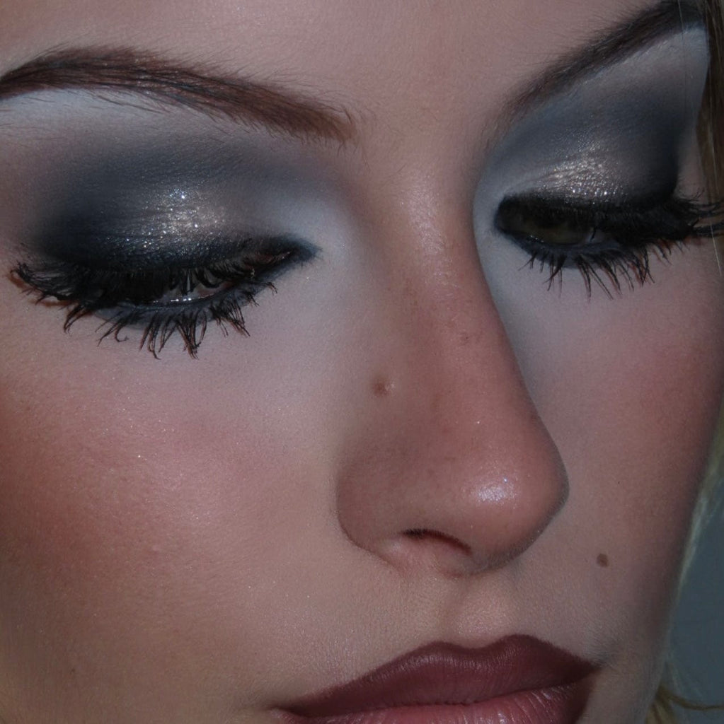 Close-up of a person's face with dramatic makeup, focusing on the eyes and nose.